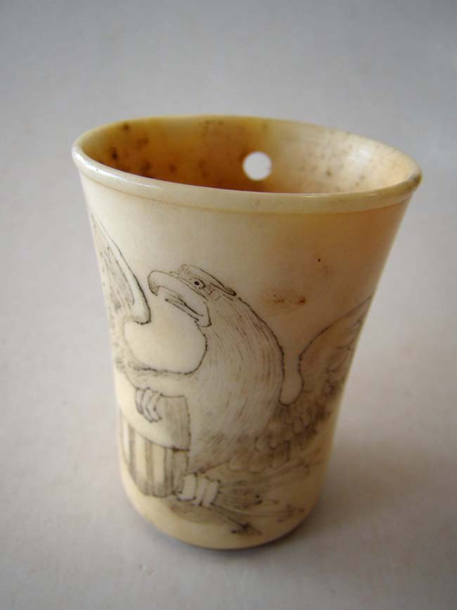 A charming 19th century scrimshawed bone cup with American eagle and the letters "U S V"